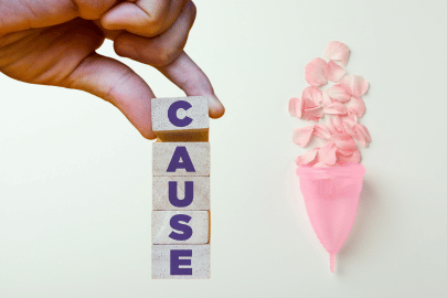 word causes and a menstrual cup filled with petals
