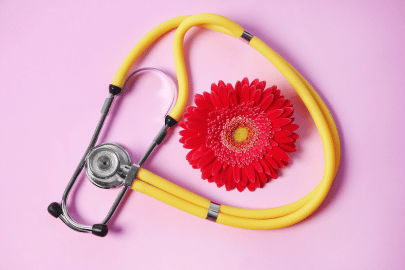 Stethoscope with flower beside it (symbol of diagnosing absent period) 